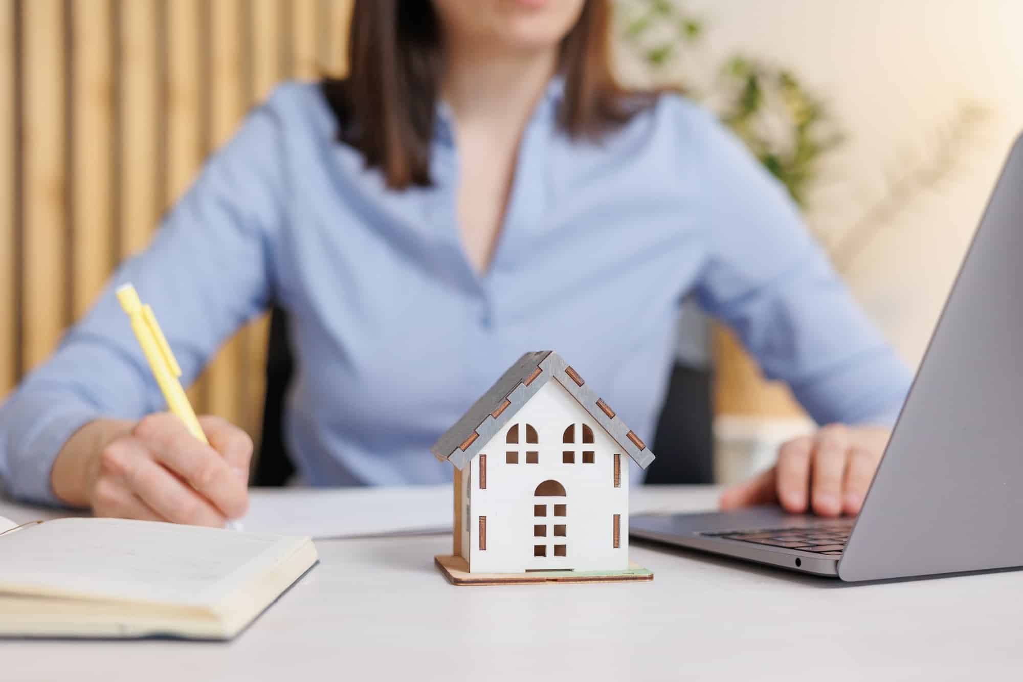 European woman buys or sells a house in a construction company. I work in the office of the company